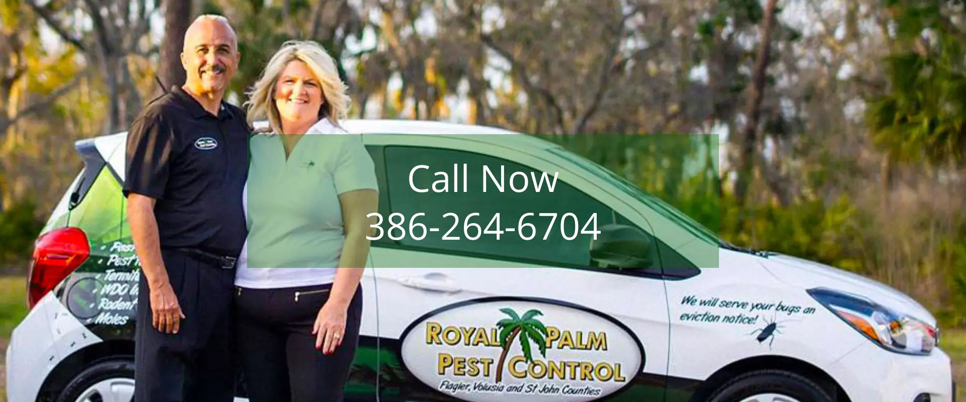 Couple standing by Royal Palm Pest Control car.